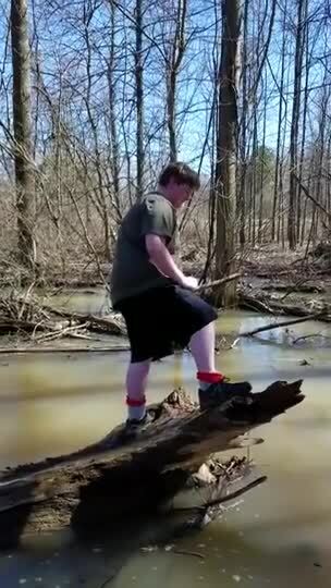 Guy Falls Into Creek From Tree Trunk