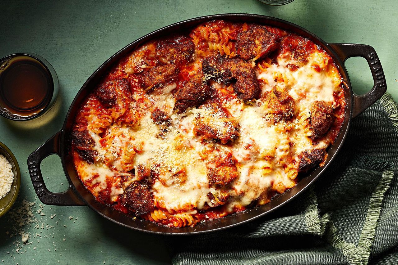overhead view of Chicken Parmesan Pasta Casserole recipe in an oval cast iron baking dish