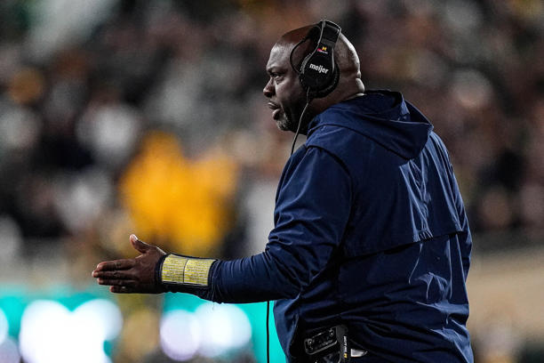 Michigan running backs coach Tony Alford talks to players before a play against Michigan State during the first half at Spartan Stadium in East Lansing on Saturday, October 25, 2025.
