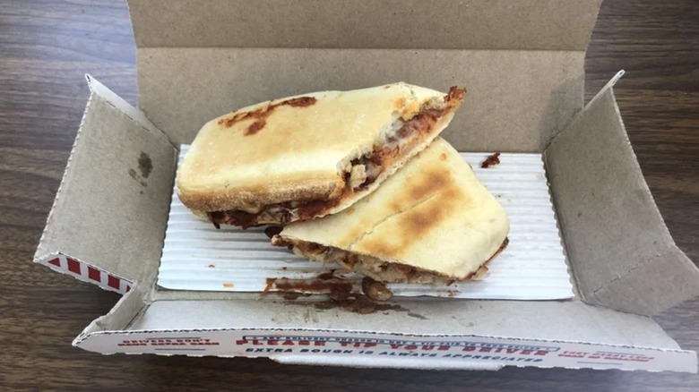 The Domino's chicken Parm sandwich sits in its box on a table.