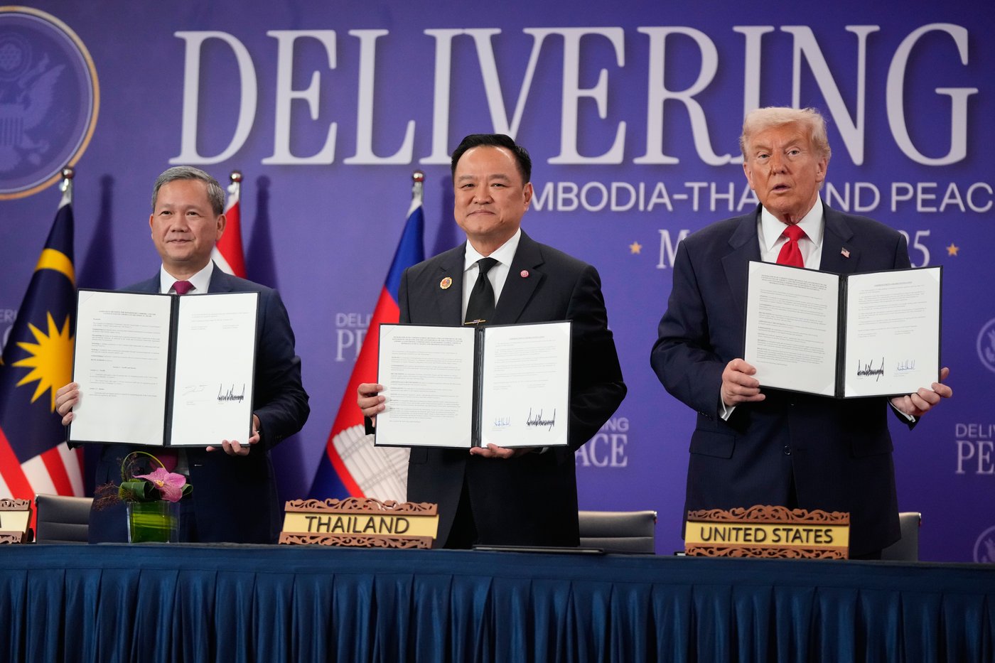 President Donald Trump, Cambodian Prime Minister Hun Manet, left, and Thailand's Prime Minister Anutin Charnvirakul pose with their documents during a signing ceremony on the sidelines of the ASEAN Summit in Kuala Lumpur, Malaysia, Sunday, Oct. 26, 2025. (AP Photo/Mark Schiefelbein)