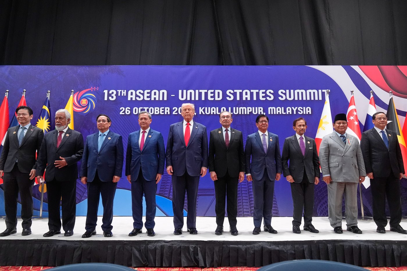 President Donald Trump poses for a family photo with, from left, Singapore Prime Minister Lawrence Wong, East Timor's Prime Minister Kay Rala Xanana Gusmao, Vietnam's Prime Minister Pham Minh Chinh, Cambodian Prime Minister Hun Manet, Malaysian Prime Minister Anwar Ibrahim, Philippine President Ferdinand Marcos Jr., the Sultan of Brunei Hassanal Bolkiah, Indonesian President Prabowo Subianto and Laos' Prime Minister Sonexay Siphandone at the ASEAN Summit in Kuala Lumpur, Malaysia, Sunday, Oct. 26, 2025. (AP Photo/Mark Schiefelbein)