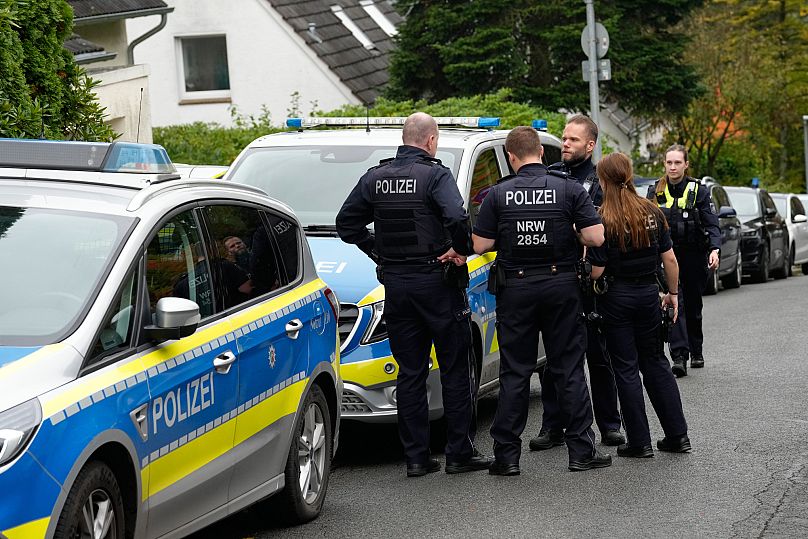 German police officers stand on a street in Herdecke, 7 October, 2025
