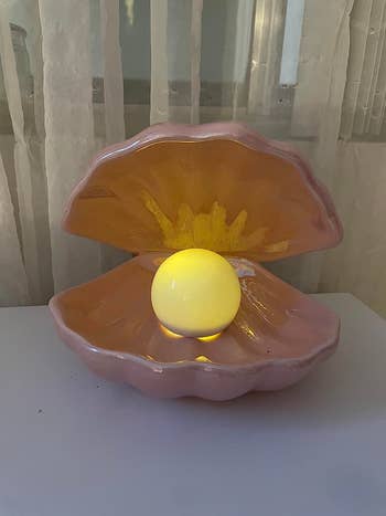 Decorative clam shell lamp with glowing pearl
