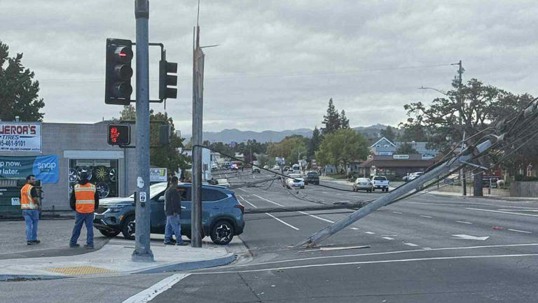 Line of toppled power poles blocks traffic on busy SLO County street ...