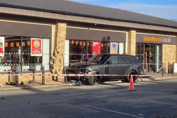 Driver arrested after crash outside shop which left man in hospital