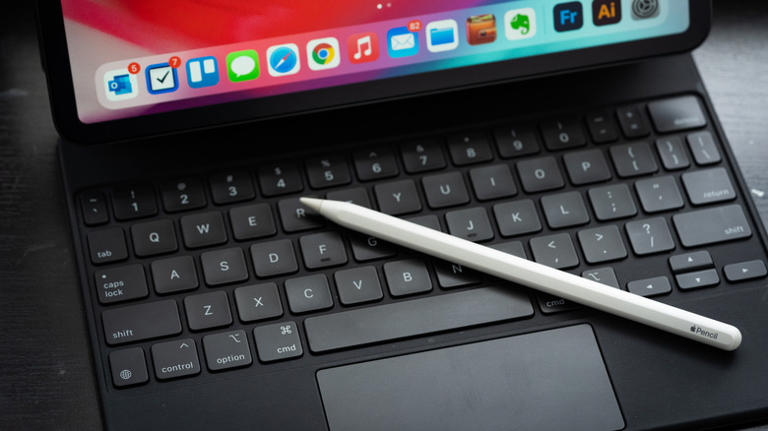 Apple pencil on top of Apple Keyboard with iPad attached