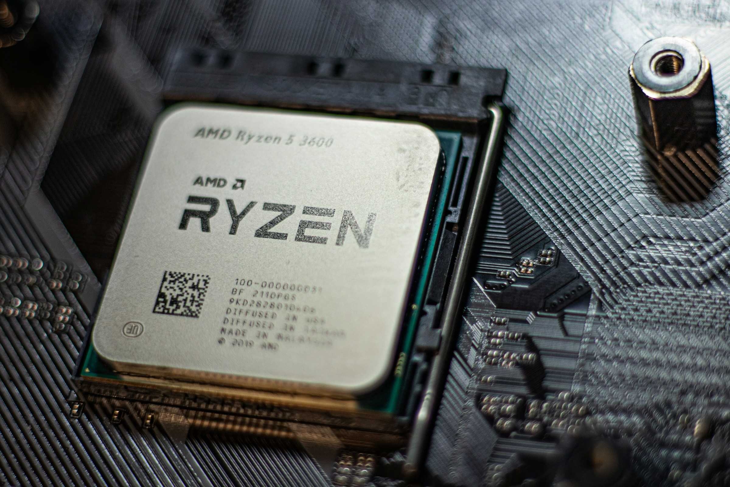 An AMD CPU installed on a black motherboard