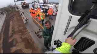 Big rig crashes and is left dangling off freeway bridge in Los Angeles!