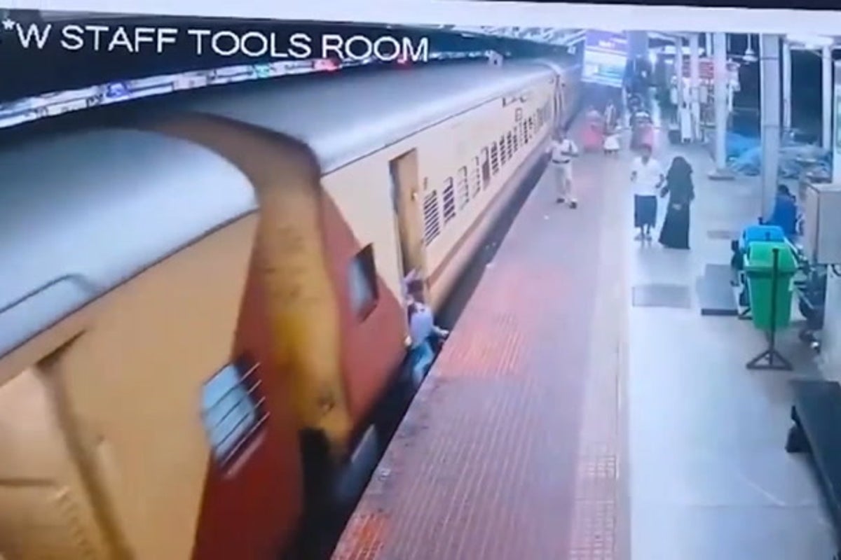 Woman who slips whilst boarding moving train saved by station guard