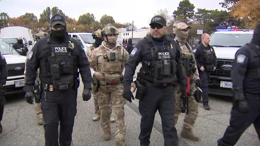 Federal agents take dozens of warehouse workers into custody in ...