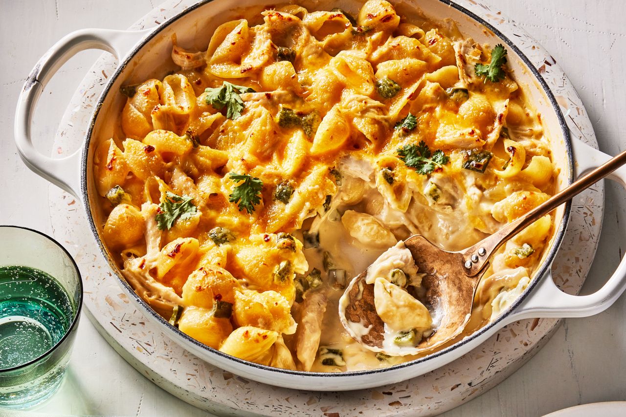 Green chile mac and cheese with chicken in white casserole dish