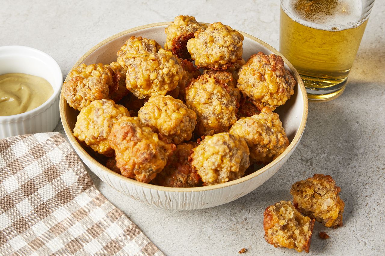 a high angle view of a bowl full of golden-brown sausage balls
