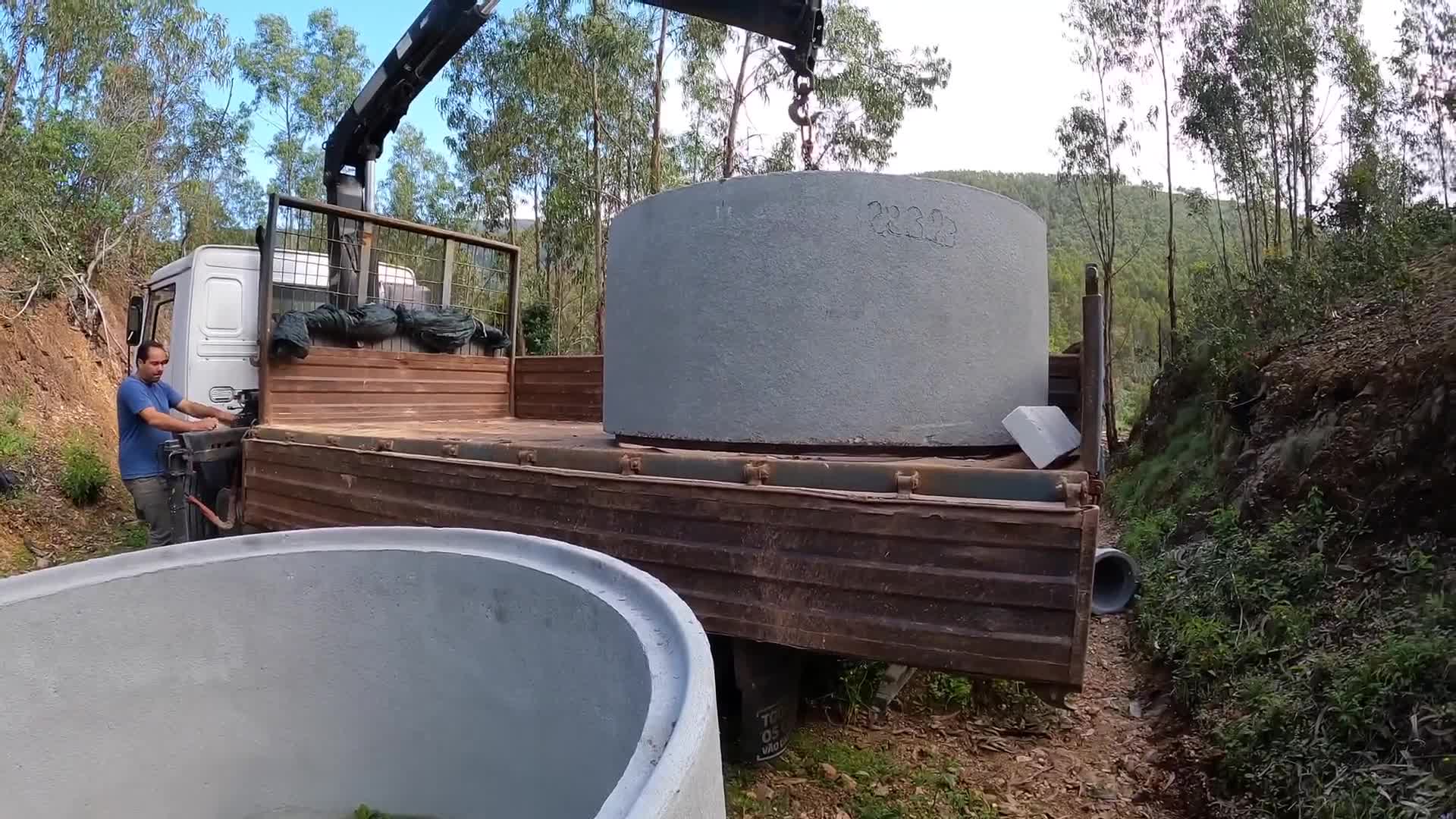 Building massive concrete water tanks for irrigation on our steep ...
