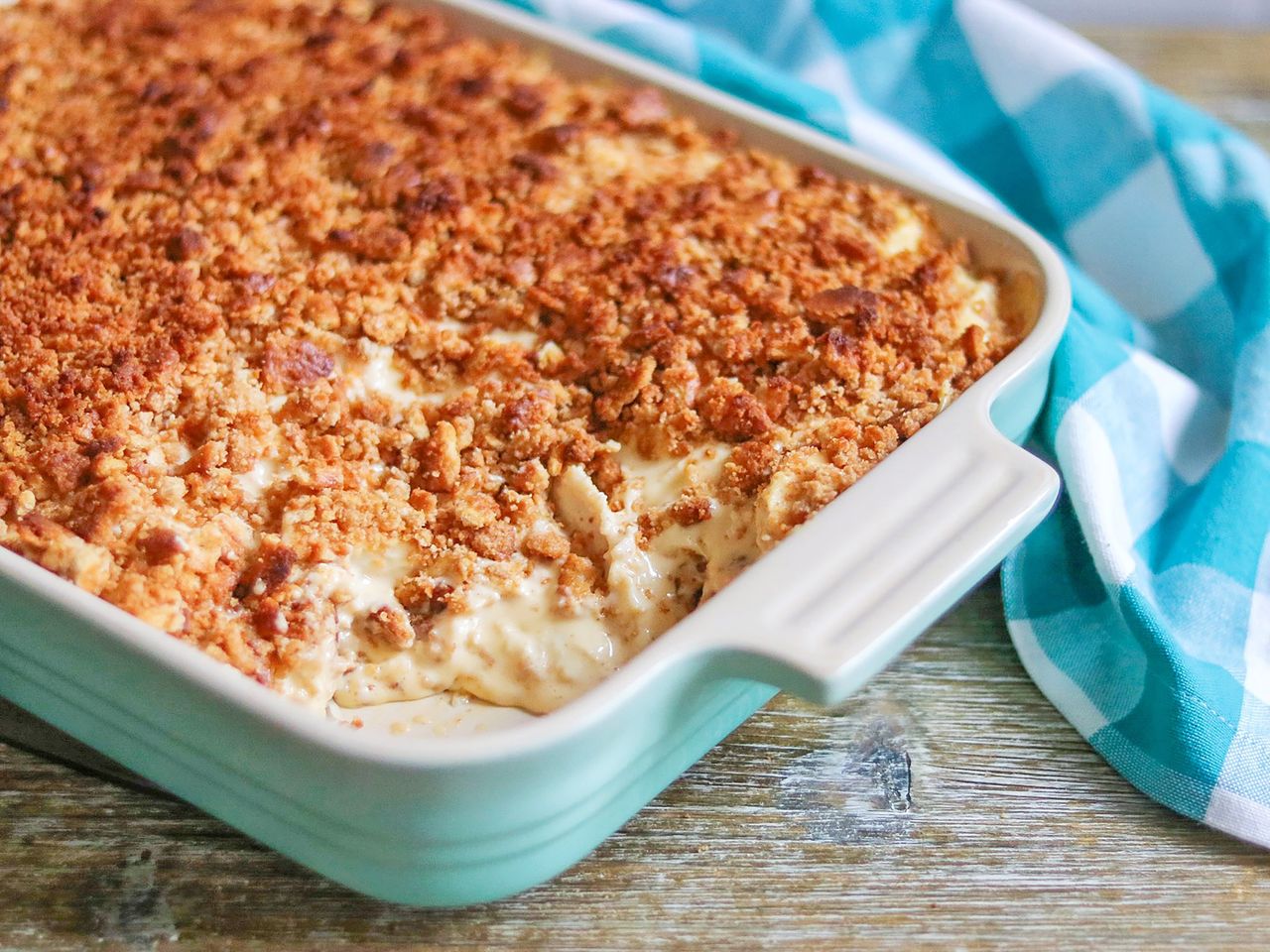 Creamy rice and chicken with crumbly crust in turquoise casserole dish