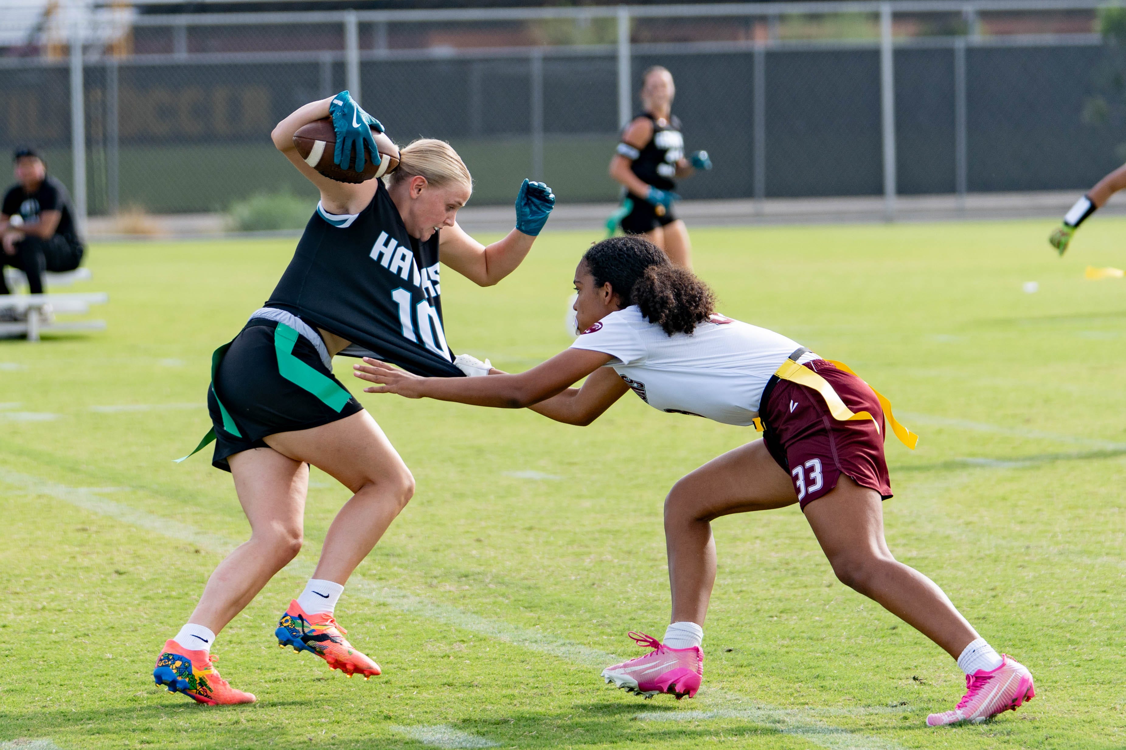 Mountain Ridge Mountain Lions Ashlynn Hazen (33) attempts to take Highland Hawks Ela Witcher’s (10) flag during the semifinals of the Fiesta Bowl Copper State Invitational at Dorsey Fields in Tempe, on Oct. 11, 2025.