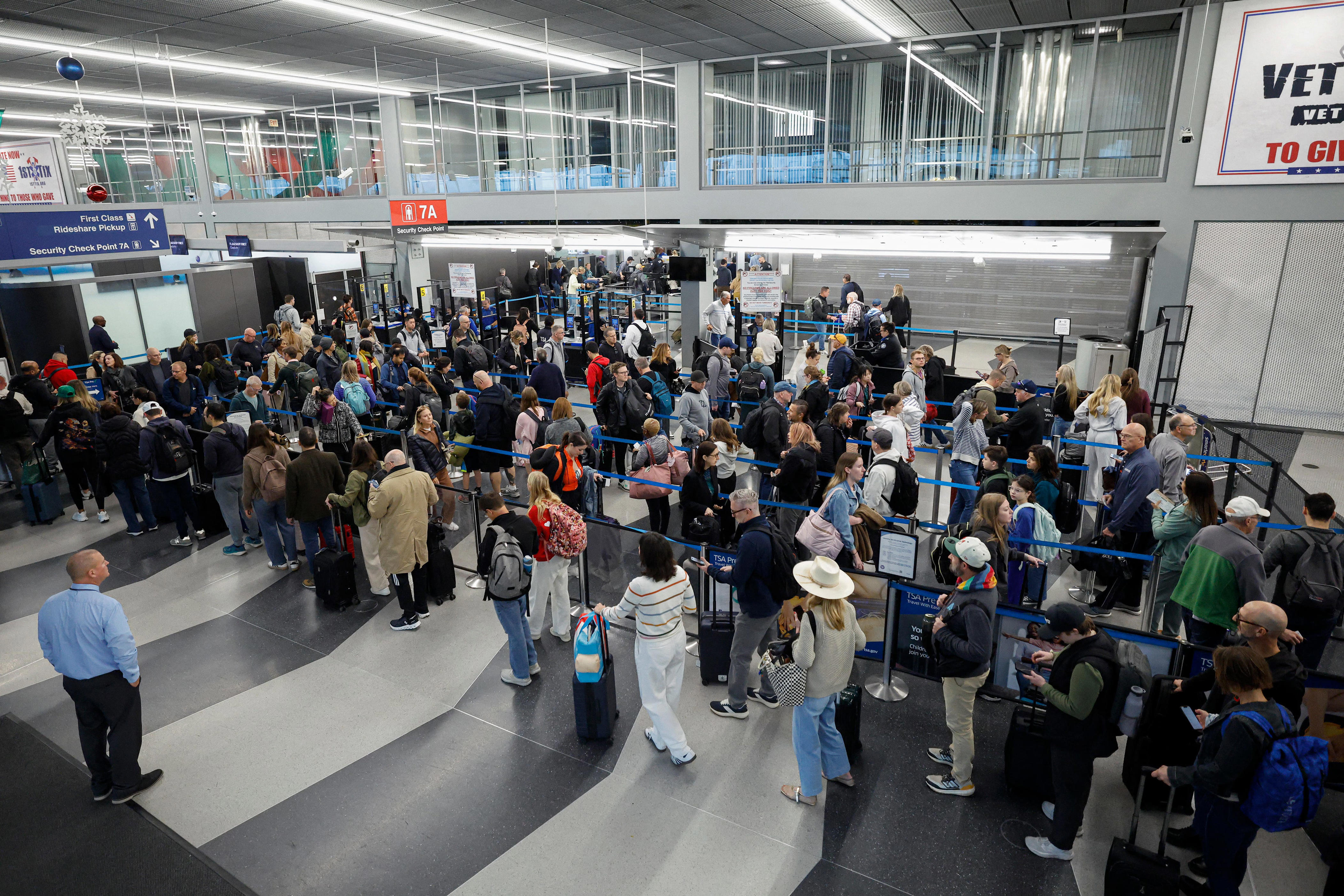 Airport travelers face flight cancellations, long lines amid government