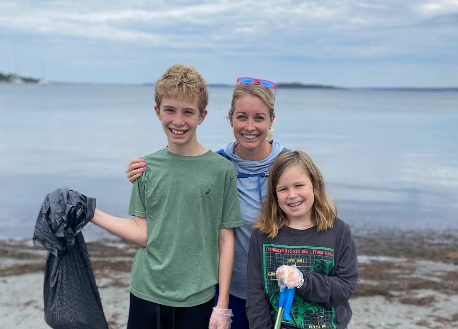The writer and her kids participating in a beach clean-up.