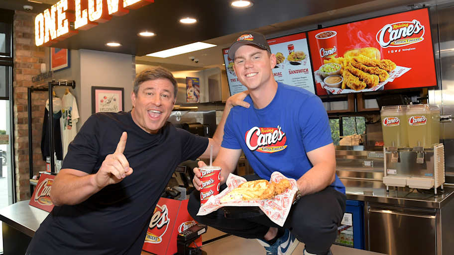 Nov 5, 2025; Los Angeles, Calif., USA; Los Angeles Dodgers Catcher Will Smith (16) poses with Raising Cane's Founder and CEO Todd Graves for a celebratory "shift" in Hollywood. | Photo courtesy of Raising Cane's