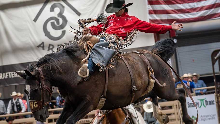 Kade Bruno riding a saddle bronc horse
