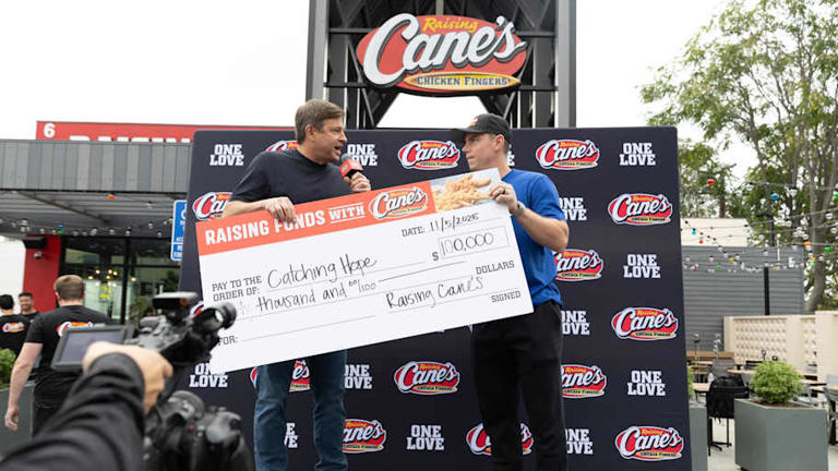 Nov 5, 2025; Los Angeles, Calif., USA; Los Angeles Dodgers catcher Will Smith (16) is presented a check for his foundation, "Catching Hope" by Raising Cane's Founder and CEO Todd Graves. | Photo courtesy of Raising Cane's