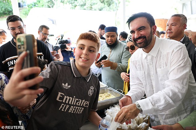 The 34-year-old, a noted soccer fan, poses for a selfie with a child in a Real Madrid jersey