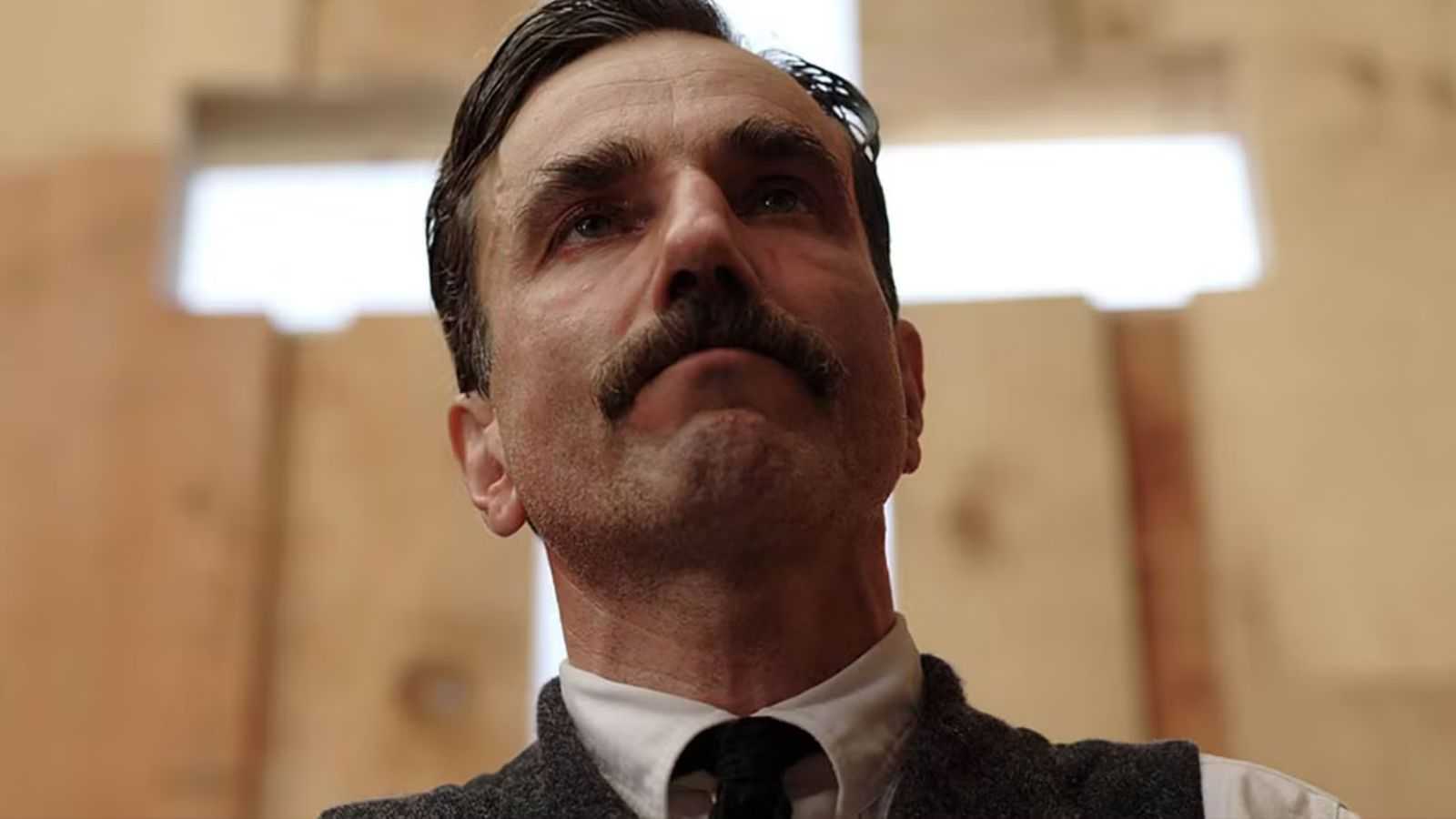 Daniel Day Lewis as Daniel Plainview kneeling in Eli's church in There Will Be Blood