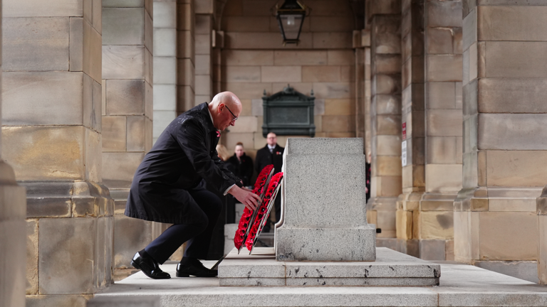 John Swinney, the first minister of Scotland, laying a wreath in Edinburgh. Pic: PA