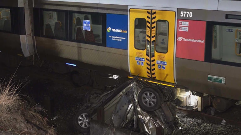 Woman's miraculous escape after becoming trapped in car on train tracks