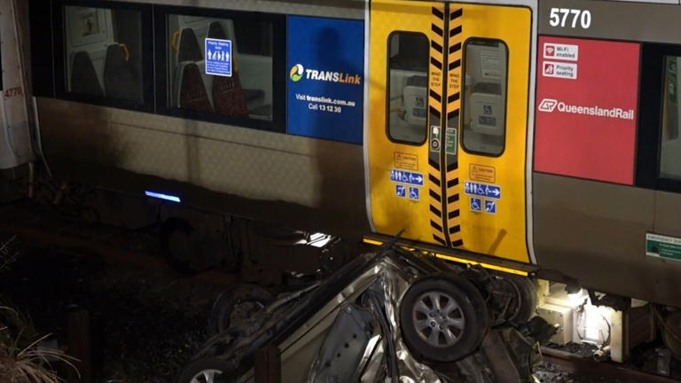 Woman's miraculous escape after becoming trapped in car on train tracks