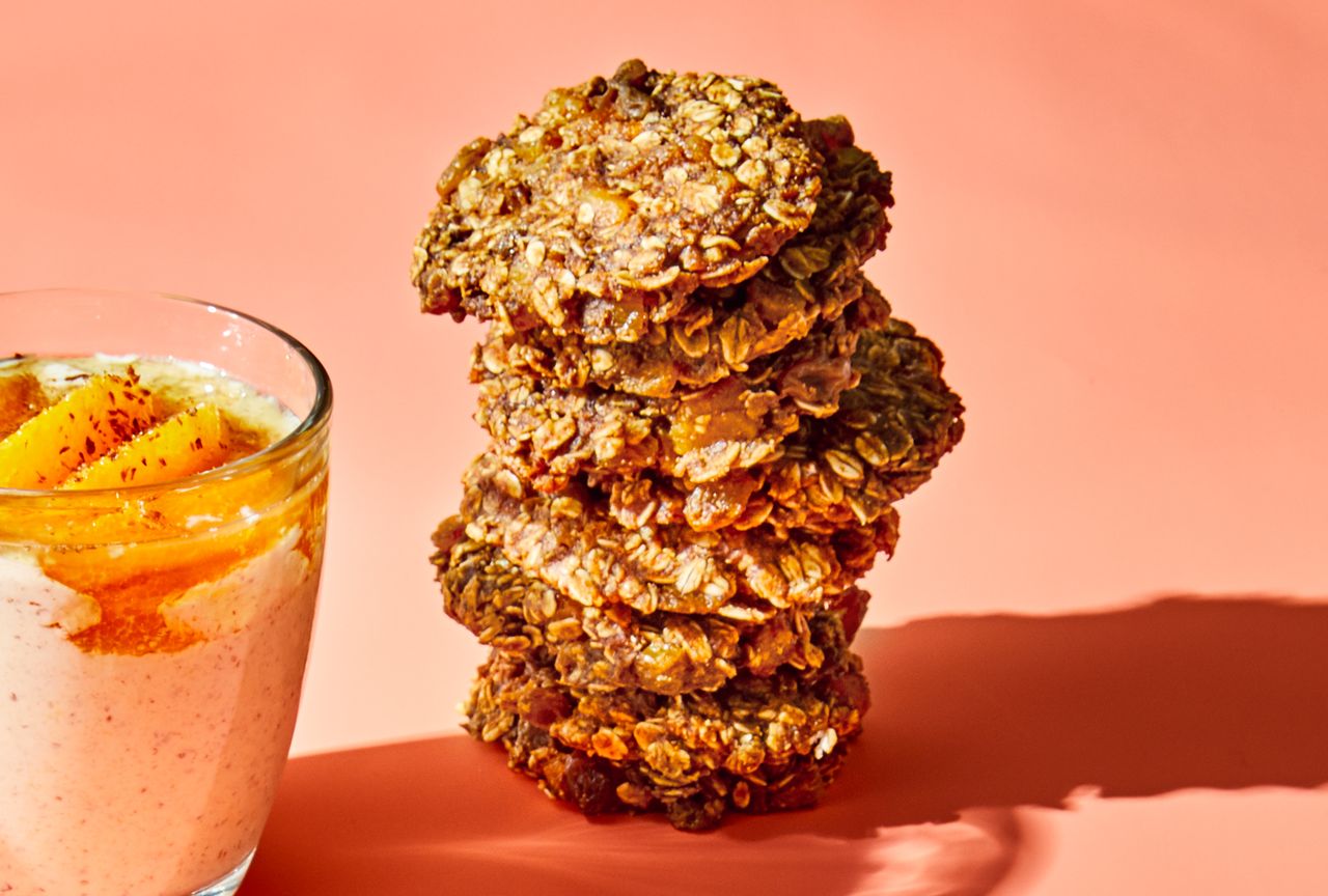 almond butter breakfast cookies with peach oats on peach colored surface
