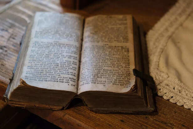 Worn and time-softened, this ancient scripture carries more than ink—it holds generations of belief, reflection, and spiritual inquiry. Each word etched into its pages speaks of a time when faith was handwritten, and understanding came through stillness and study.
