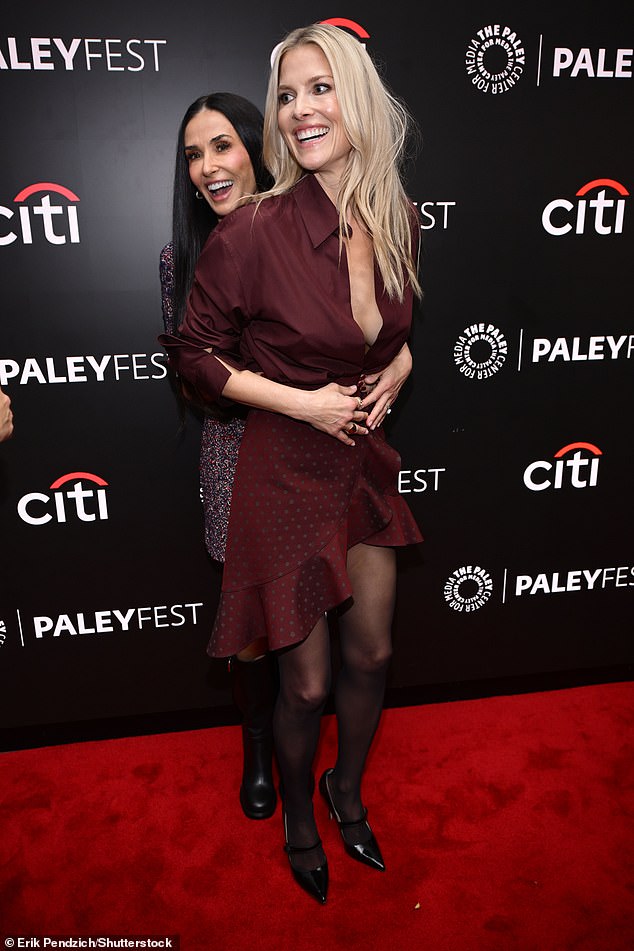 Ali showed off her amazing figure as she went braless under an unbuttoned burgundy shirt which she tucked into a coordinated spotted ruffled miniskirt