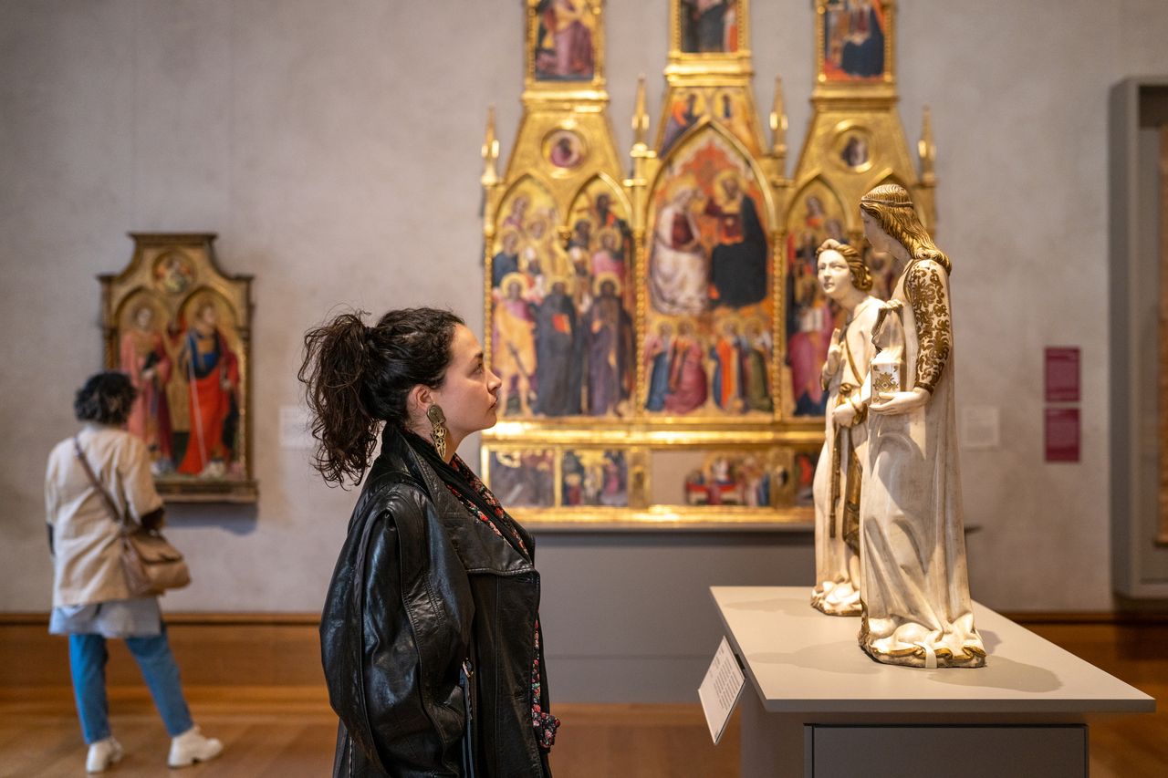 A woman observing statues in the Getty Center