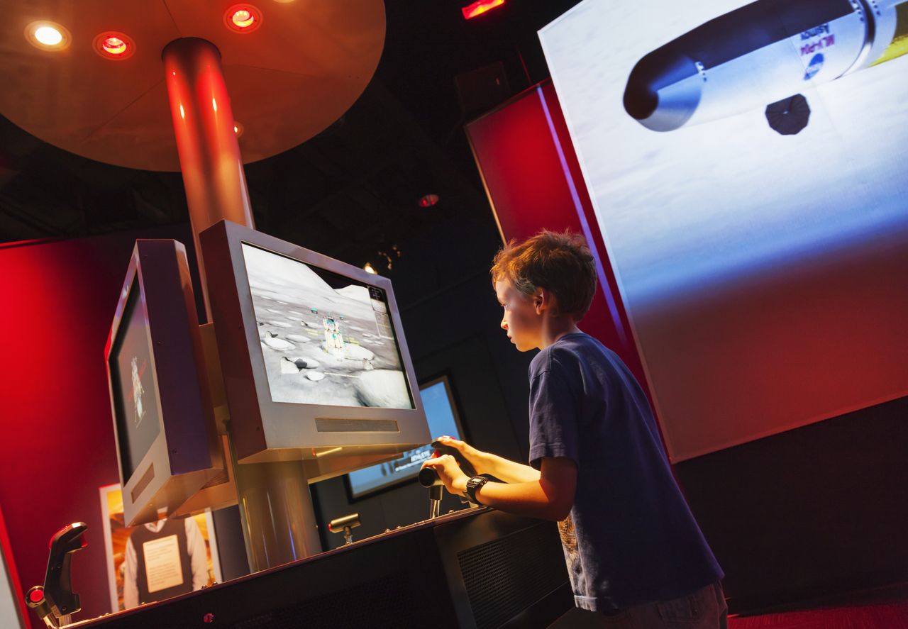 A child plays with an interactive display at the Kennedy Space Center.