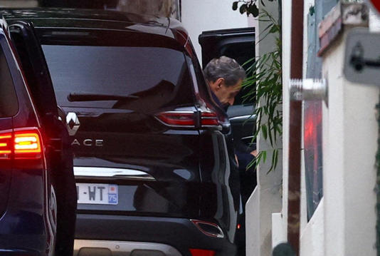 Sarkozy, pictured arriving at his house on Monday, spent three weeks in prison before his lawyers secured his release (Reuters)