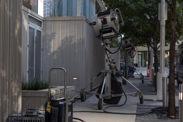 Production lights can be seen outside the KPMG Plaza on Nov. 17, 2025 in downtown Dallas.