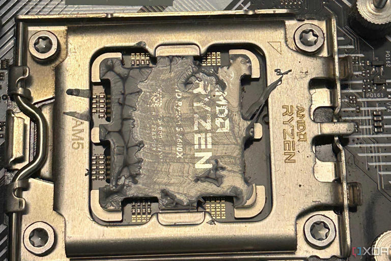 Dried-up thermal paste on a Ryzen 5 7600X chip.