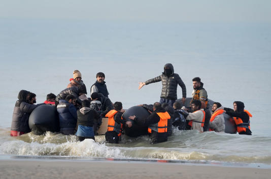 People thought to be migrants attempt to board a small boat in Gravelines, France - where many wait the opportunity to travel across the English Channel to the UK (Gareth Fuller/PA Wire)