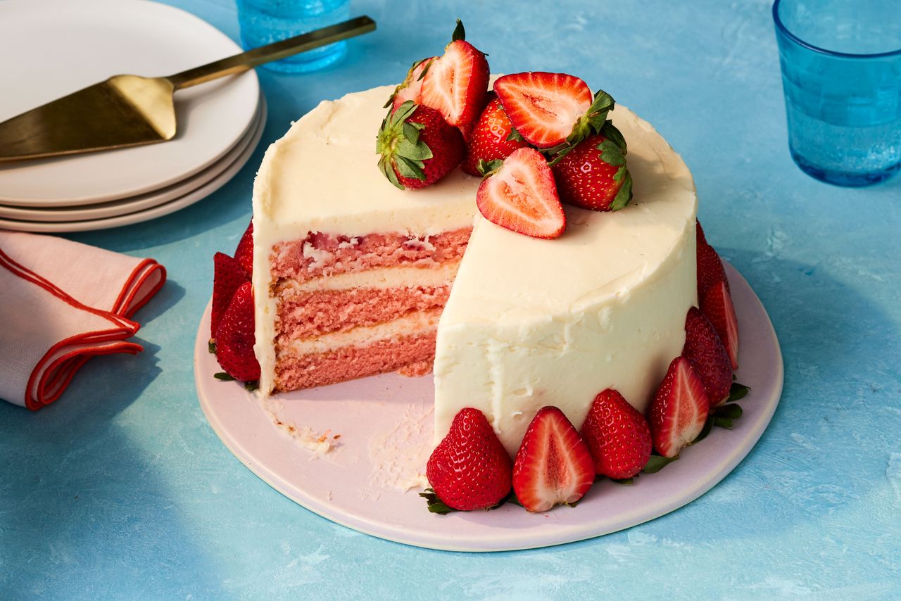 Southern Living Strawberry Vanilla Cake sliced on a cake plate to serve