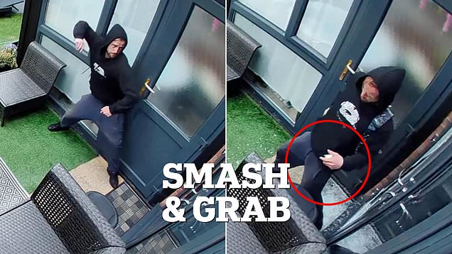 Moment burglar smashes his way into property before stealing phone