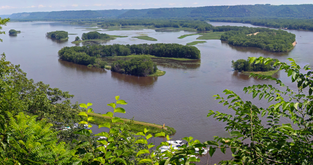 Mississippi River at Lansing Iowa from cliffs high above. Forested islands in the river.