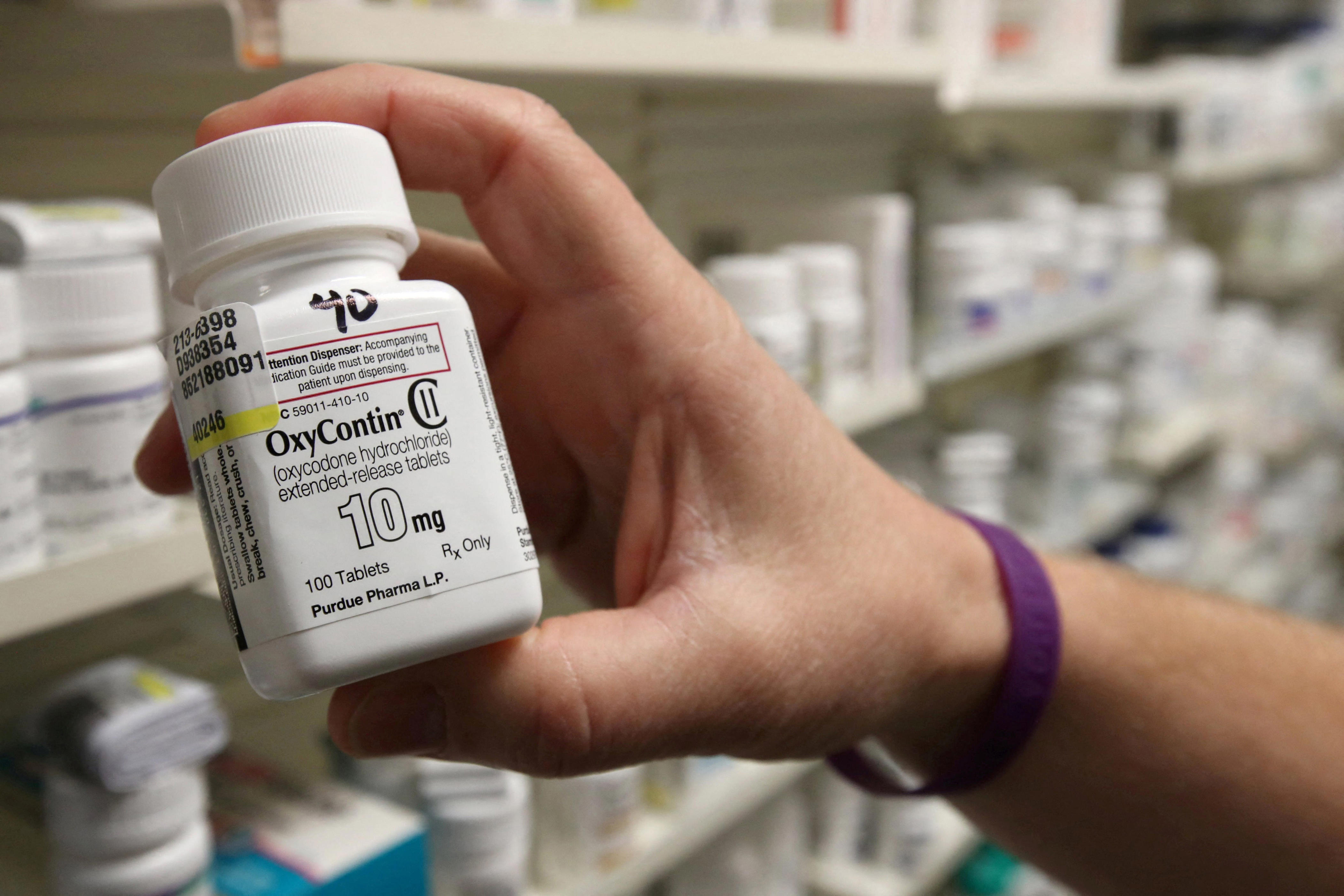 A pharmacist holds a bottle OxyContin made by Purdue Pharma at a pharmacy in Provo, Utah, U.S., May 9, 2019.