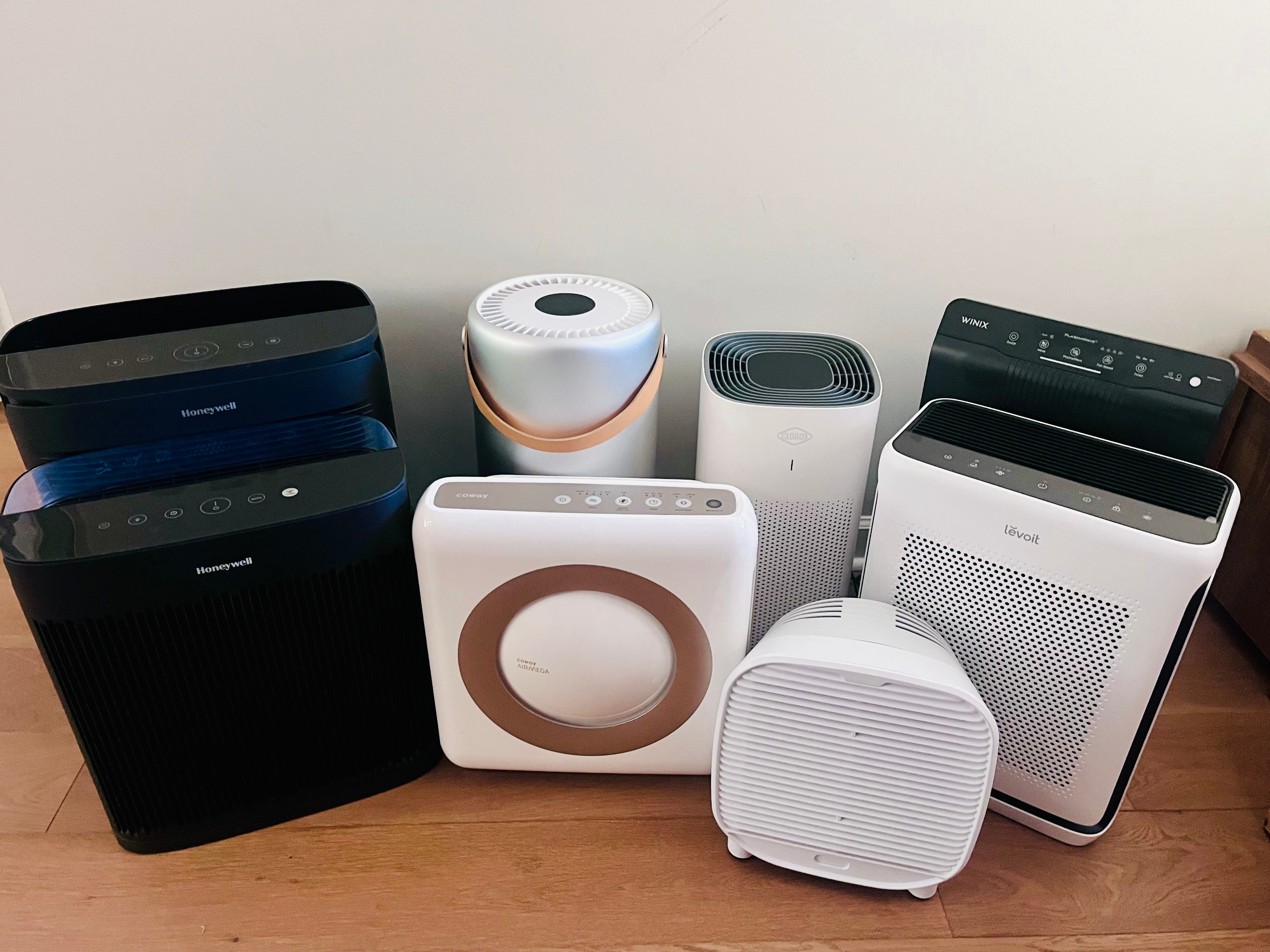 assortment of 8 air purifiers grouped together
