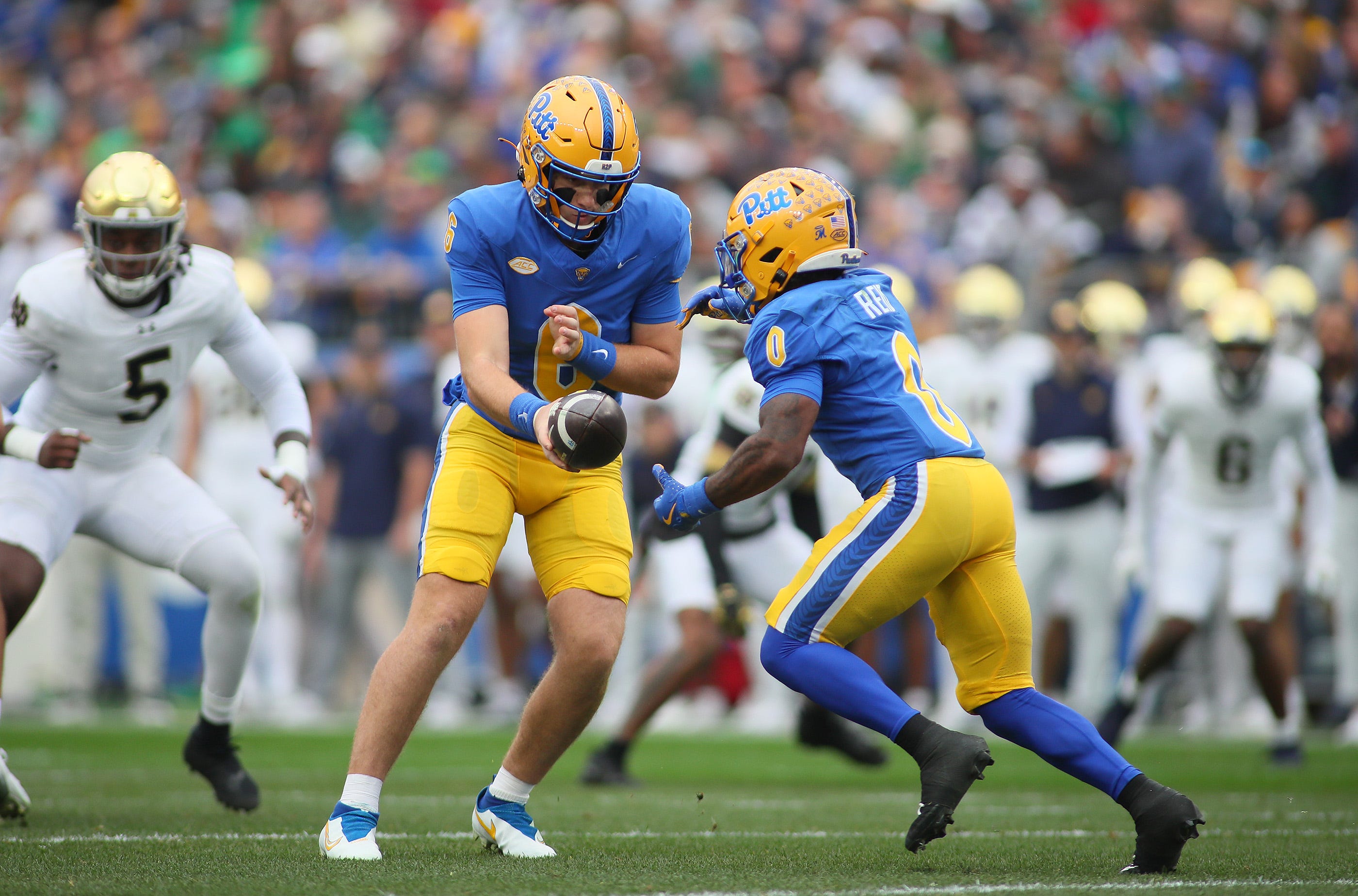 Pittsburgh Panthers quarterback Mason Heintschel (6) hands the ball off to running back Desmond Reid (0) during the first half against the Notre Dame Fighting Irish at Acrisure Stadium in Pittsburgh, PA on November 15, 2025.