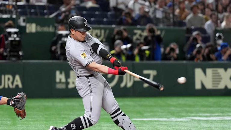 Mar 16, 2025; Bunkyo, Tokyo, Japan; Yomiuri Giants first baseman Kazuma Okamoto (25) hits a single against the Chicago Cubs during the second inning at Tokyo Dome. Mandatory Credit: Darren Yamashita-Imagn Images | Darren Yamashita-Imagn Images