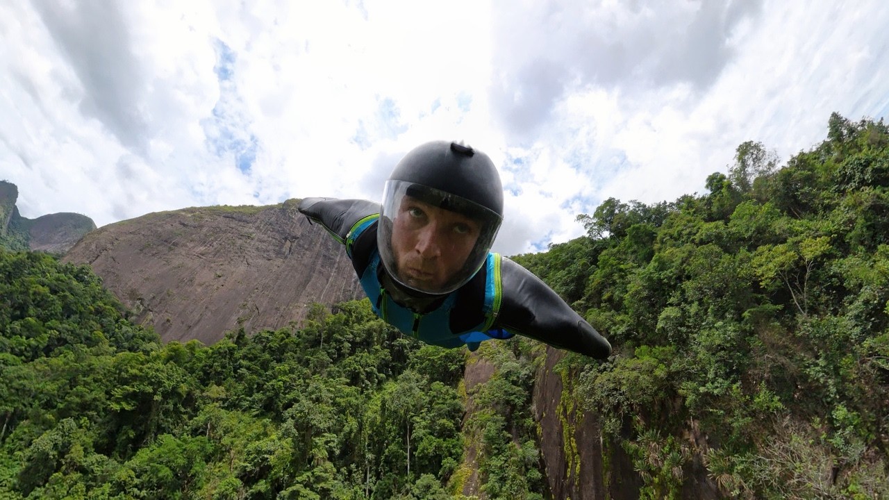 Man launches a wingsuit BASE jump off Zorzi’s Ramp in Brazil.