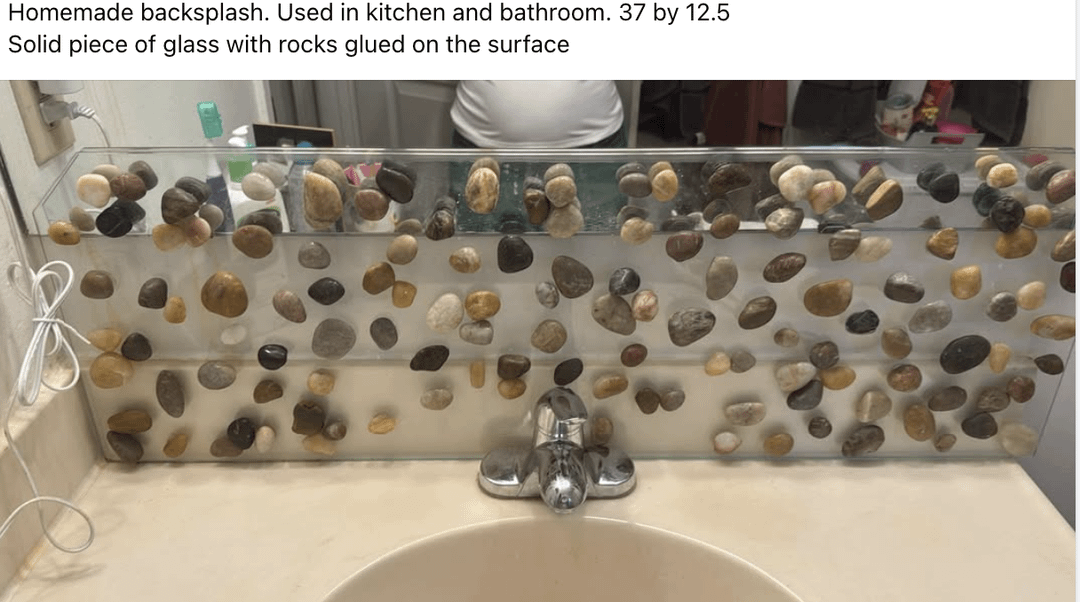 Homemade backsplash with rocks glued on glass, used in kitchen and bathroom, measuring 37 by 12.5 inches