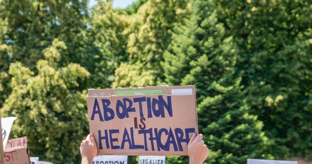 Protesters holding pro-abortion signs at demonstration in response to the Supreme Court Dobbs ruling overturning Roe v. Wade.