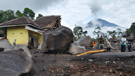 People inspect the damage caused by the eruption of Mount Semeru in Lumajang, East Java, Indonesia. Pic: AP